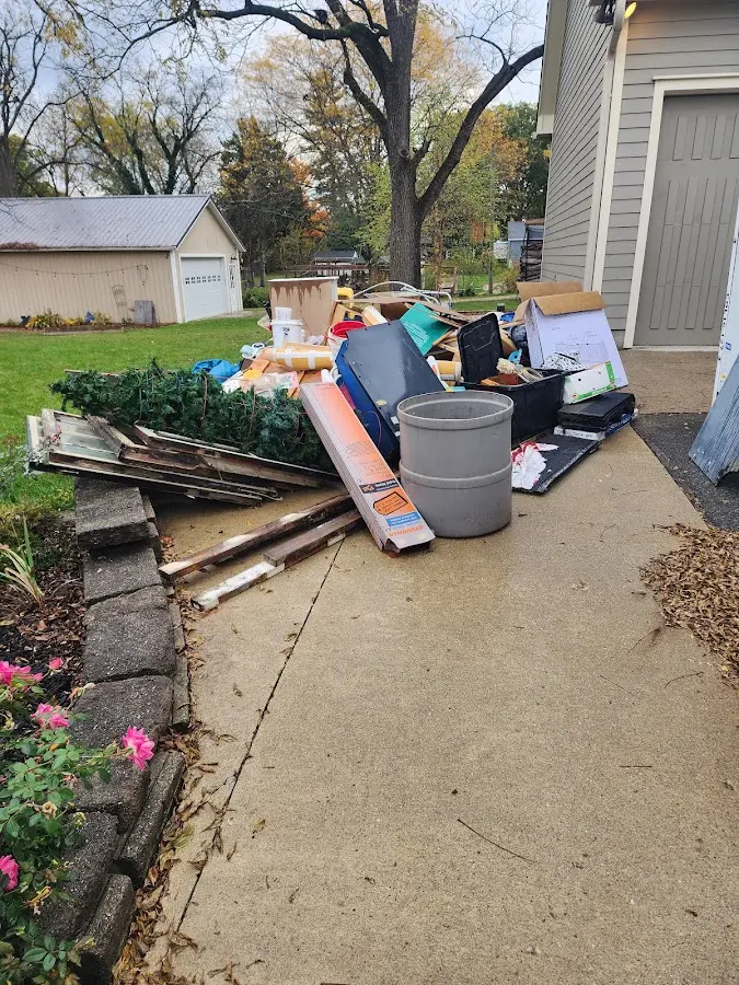 Dumpster being loaded with debris for Roofing Dumpster Rental in Carmel